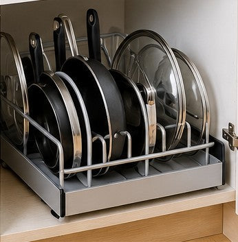 Pots, pans and glass lids arranged vertically in a cabinet organizer