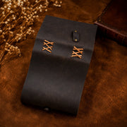 Back cover of leather journal showing cross-laced binding